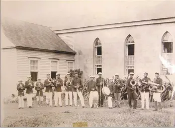  ??  ?? HAWAII STATE ARCHIVES photo The Kalawao Boys Band stands outside St. Philomena Church in Kalawao on the peninsula of Kalaupapa in 1905. Performers will honor the musical traditions of Kalaupapa during a virtual concert on Oct. 17.