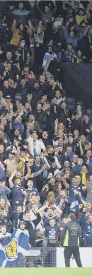  ?? ?? 2 Scotland players celebrate with the fans after the dramatic victory at Hampden