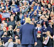  ??  ?? Donald Trump, right, uses a rally in Des Moines, Iowa, left, to attack his Democratic rivals as ‘Left-wing extremists’