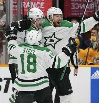  ?? George Walker IV/Associated Press ?? Dallas’s Sam Steel, Craig Smith, second from left and Jani Hakanpaa celebrate Hakanaa’s goal that gave the Stars an improbable win against the Predators Saturday in Nashville, Tenn.