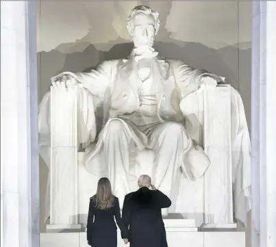  ??  ?? President-elect Donald Trump salutes as he arrives with his wife, Melania, to the “Make America Great Again Welcome Concert” Thursday at the Lincoln Memorial in Washington, D.C.