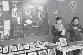  ?? PROVIDED TO CHINA DAILY ?? Patissier Zhou Chuanmei (right) makes a type of stuffed dumpling ball made of glutinous rice flour for Lantern Festival, with one of her apprentice­s at an exhibition for intangible cultural projects held at the Confucius Museum in Qufu, Shandong province, on Wednesday. Right: Huang Sihan (right) and her teacher show their paper-cutting skills at the exhibition.