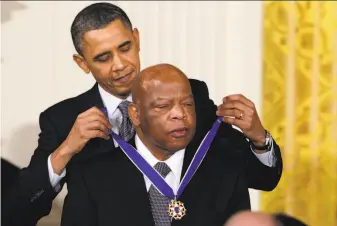  ?? Carolyn Kaster / Associated Press 2011 ?? President Barack Obama presents the Presidenti­al Medal of Freedom to Rep. John Lewis, DGa., during a 2011 ceremony at the White House. Lewis died Friday at age 80.