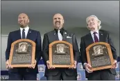  ?? HANS PENNINK — THE ASSOCIATED PRESS ?? Hall of Fame inductees, from left, Derek Jeter, Larry Walker and Ted Simmons hold their plaques for photos after the induction ceremony at Clark Sports Center on Wednesday at the National Baseball Hall of Fame in Cooperstow­n, N.Y.