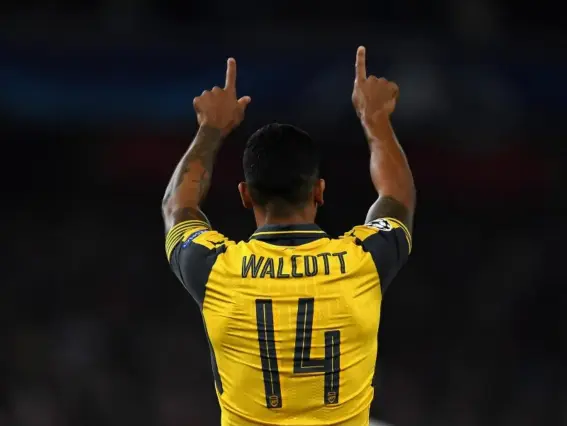  ??  ?? Walcott salutes the Emirates support after scoring against Basel (Getty)