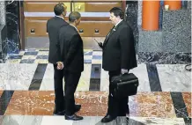  ?? Picture: ESA ALEXANDER ?? MEN IN BLACK: Parliament­ary security services guards dressed in suits stand in front of the main entrance to the National Assembly