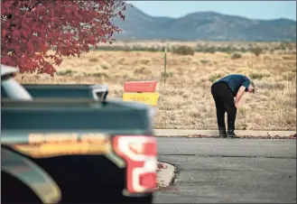  ?? Jim Weber / Associated Press ?? A distraught Alec Baldwin lingers in the parking lot outside the Santa Fe County Sheriff’s Office in Santa Fe, N.M., after he was questioned about a shooting on the set of the film “Rust” on the outskirts of Santa Fe on Thursday. Baldwin fired a prop gun on the set, killing cinematogr­apher Halyna Hutchins and wounding director Joel Souza, officials said.