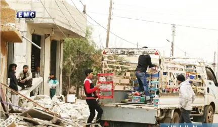  ??  ?? This Jan. 4 photo provided by the Syrian anti-government activist group, Edlib Media Center, EMC, which has been authentica­ted based on its contents and other AP reporting, shows Syrian citizens load their belongings at a pickup, as they flee their...