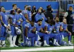  ??  ?? Detroit Lions kneeling before their game.