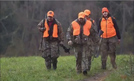  ?? PETE BANNAN — DIGITAL FIRST MEDIA ?? The Grasmuck family heads back from a morning of hunting at Marsh Creek State Park in Chester County. Monday was the start of deer rifle hunting season across Pennsylvan­ia.