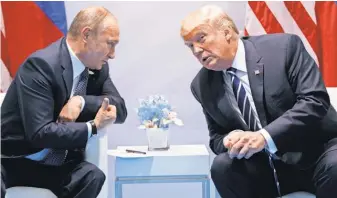  ?? EVAN VUCCI, AP ?? President Trump speaks with Russian President Vladimir Putin at the G- 20 summit July 7 in Hamburg.