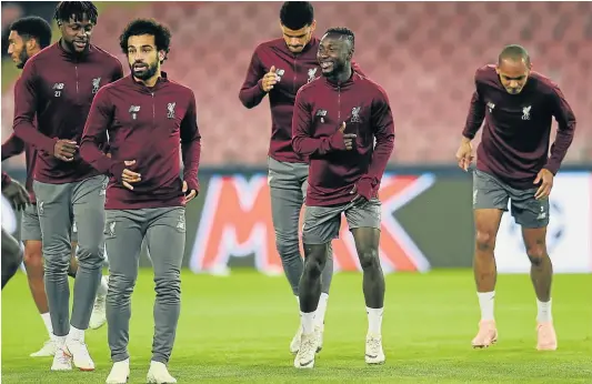  ?? Picture: Andrew Powell/Liverpool FC via GETTY IMAGES ?? IN FORMATION: Naby Keita, second from the right, is all smiles as he joins his Liverpool teammates during a training session held at Stadio San Paolo in Naples, Italy on Tuesday.