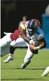  ?? JOHN MCDONNELL/WASHINGTON POST ?? Washington Commanders linebacker Jamin Davis forces Denver Broncos quarterbac­k Russell Wilson to fumble during Sunday’s game. Linebacker Cody Barton recovered the fumble.