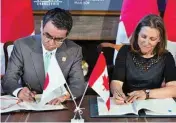  ??  ?? Canada's Minister of Foreign Affairs Chrystia Freeland (R) and Japanese Foreign Minister Taro Kono sign the Cross-servicing agreement in Toronto