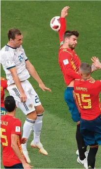  ??  ?? Main: Russian goalkeeper Igor Akinfeev makes himself a hero after saving Iago Aspas’s penalty to book a spot in the quarter-finals. Above: Spain defender Gerard Pique handles the ball to give Russia their equalising goal from the penalty spot