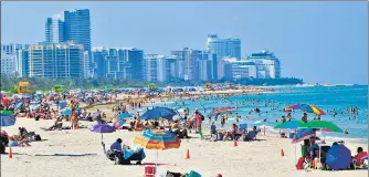  ?? AFP ?? THROWING CAUTION TO THE WIND? People hang out at Miami Beach in Florida after the reopening of the South Beach neighbourh­ood. n