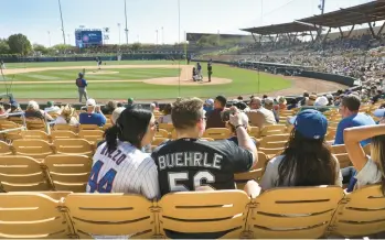  ?? CHRIS SWEDA/CHICAGO TRIBUNE ?? Fans take in a 2022 spring training game between the White Sox and the Cubs in Glendale, Ariz.