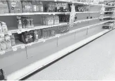  ?? WAYNE K. ROUSTAN/SOUTH FLORIDA SUN SENTINEL ?? Bottled water is being sold so fast that some stores have given up restocking shelves and just leave full pallets of water at the front door.