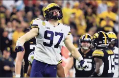  ?? Justin Casterline / TNS ?? Michigan’s Aidan Hutchinson reacts after a sack during the second quarter in the Big Ten Championsh­ip against Iowa in December.