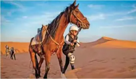  ??  ?? A rider competes during the “Gallops of Morocco” equestrian race in the desert of Merzouga.