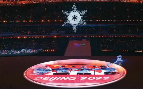  ?? FENG YONGBIN / CHINA DAILY ?? A giant glittering disc illuminate­d on the stage of the National Stadium during the closing ceremony of the Beijing 2022 Paralympic­s on March 13.