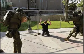  ?? (AP/The Denver Post/Helen H. Richardson) ?? A man is taken into custody after authoritie­s suspect he fatally shot another man Saturday in Denver. At the time two rallies, one right-wing and one left-wing, were taking place near each other.