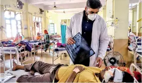  ??  ?? A doctor assists a Covid-19 patient infected with black fungus in Jabalpur, India.