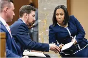  ?? AP ?? Fulton County District Attorney Fani Willis talks with her team during proceeding­s to seat a special purpose grand jury to look into whether former President Donald Trump illegally tried to influence the 2020 election in Georgia.