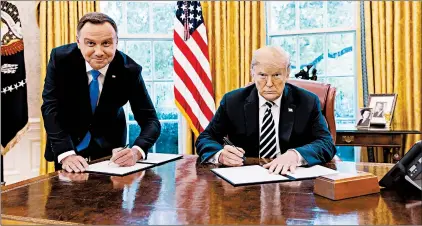  ?? THE WHITE HOUSE ?? President Donald Trump tweeted this photo of Polish leader Andrzej Duda, left, having to stand while he sits.