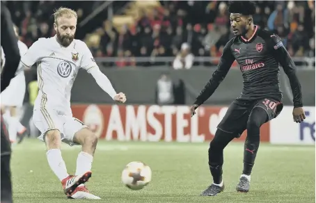  ??  ?? Former Northern League player Curtis Edwards (left) lines up a shot for Ostersund under pressure from Arsenal’s Ainsley Maitland-Niles.