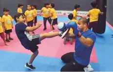  ?? Abdul Rahman/Gulf News ?? 38-year-old Brazilian instructor Alessandro Rodrigues lets children get a feel of boxing. He also trains them in acrobatics.