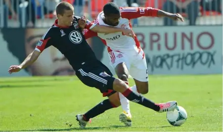  ?? CARLOS OSORIO/TORONTO STAR ?? D.C. United’s Collin Martin, left, battles Ashtone Morgan of Toronto FC during first-half action Saturday at BMO Field. TFC won 4-1.