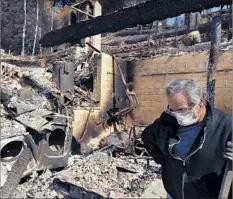  ?? Genaro Molina Los Angeles Times ?? BRUCE COSTELLO, 62, spends a quiet moment last week in the rubble of his home, which was razed by the recent fires in Sonoma County.