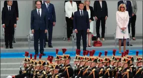  ?? (AP/Francois Mori) ?? French Prime Minister Jean Castex (front from left), President Emmanuel Macron and wife Brigitte Macron watch the Bastille Day military parade Tuesday in Paris.More photos at arkansason­line.com/ 715france/.