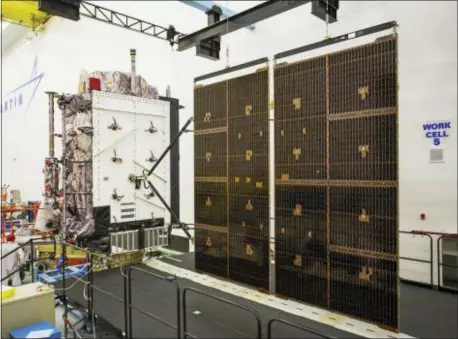  ?? PAT CORKERY — LOCKHEED MARTIN VIA AP ?? This photo provided by Lockheed Martin shows the second GPS III satellite during testing of the deployment of its solar arrays in a clean room at Lockheed Martin’s complex south of Denver. The first GPS III satellite is scheduled to be launched from Cape Canaveral, Fla., on Tuesday.