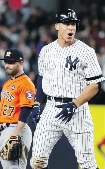  ?? PHOTOS: AL BELLO/GETTY IMAGES ?? New York Yankees outfielder Aaron Judge reacts after hitting a double against the Houston Astros during the eighth inning of Game 4 of the American League Championsh­ip Series in New York on Tuesday. He was later driven in on a decisive two-RBI double...