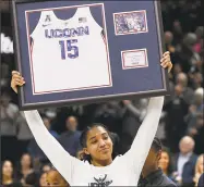  ?? Jessica Hill / Associated Press ?? UConn’s Gabby Williams holds up a jersey with her number during a Senior Night ceremony before a game against South Florida on Monday