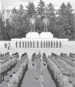  ?? AFP / GETTY IMAGES ?? North Korea military personnel gather Aug. 11 in a rally in support of the regime’s stance against the U.S. in an official Korean Central News Agency photo.