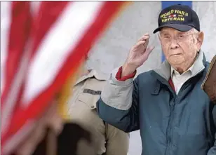  ?? GARY CORONADO LOS ANGELES TIMES ?? WORLD WAR II veteran Louis Moore, 98, attends a f lag ceremony before a book signing for his memoir, “Eternal Love,” at the American Legion Post 311 in Lancaster this month.