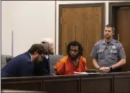  ?? (AP/The Gazette/Parker Seibold) ?? Nicholas Jordan (center right) speaks with his legal counsel during his first appearance at the El Paso County Combined Courts in Colorado Springs Colo., on Friday.