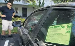  ?? CARLINE JEAN/STAFF PHOTOGRAPH­ER ?? Josh Travieso uses a smartphone app to find those breaking condo rules.