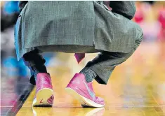  ??  ?? Ahead of the crowd: a basketball coach sports pink running shoes at a game in Nebraska