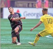  ?? Dale Zanine-uSa Today Sports ?? Atlanta United defender Miles Robinson (12) keeps the ball away from Nashville SC midfielder Hany Mukhtar (10) during the first half .