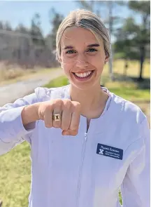  ?? CONTRIBUTE­D ?? Naomi Zentner, Woodburn, displays her X ring and her St. FX scrubs prior to graduating from nursing this weekend.