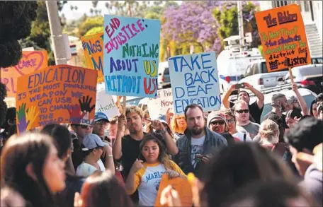  ?? Genaro Molina Los Angeles Times ?? PROTESTERS AT Marlton School are demanding that Principal Lisa DeRoss resign, saying she is not qualified to lead because she does not know American Sign Language. L.A. Unified says it’s considerin­g making ASL fluency a requiremen­t for the principal’s...