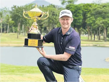  ?? ASIAN TOUR ?? Justin Harding poses with the trophy after winning the Royal Cup at the Phoenix Gold Golf and Country Club in Pattaya.