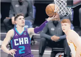  ?? JAREDC. TILTON/ GETTY ?? Hornets rookiePGLa­Melo Ball, at 19 years old, on Saturday night became the youngest player in league history to record a triple- double in a victory over the Hawks.