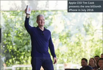  ??  ?? Apple CEO Tim Cook presents the one billionth iPhone in July 2016