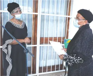  ??  ?? Defence and War Veterans Affairs Minister Oppah Muchinguri-Kashiri (left) delivers a letter of conferment of national hero status to Cde Morton Malianga’s widow Effie in Greystone Park, Harare yesterday. — Picture: Justin Mutenda