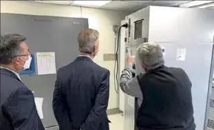  ?? Courtesy of congressma­n Lynch’s office ?? Va Boston Healthcare system director Vincent ng, left, u.s. rep stephen Lynch, center, and associate chief of the pharmacy antoun Houranieh look at a cord in the back of the freezer that came out, spoiling 1,900 doses of the coronaviru­s vaccine at the the Jamaica Plain Va medical center.